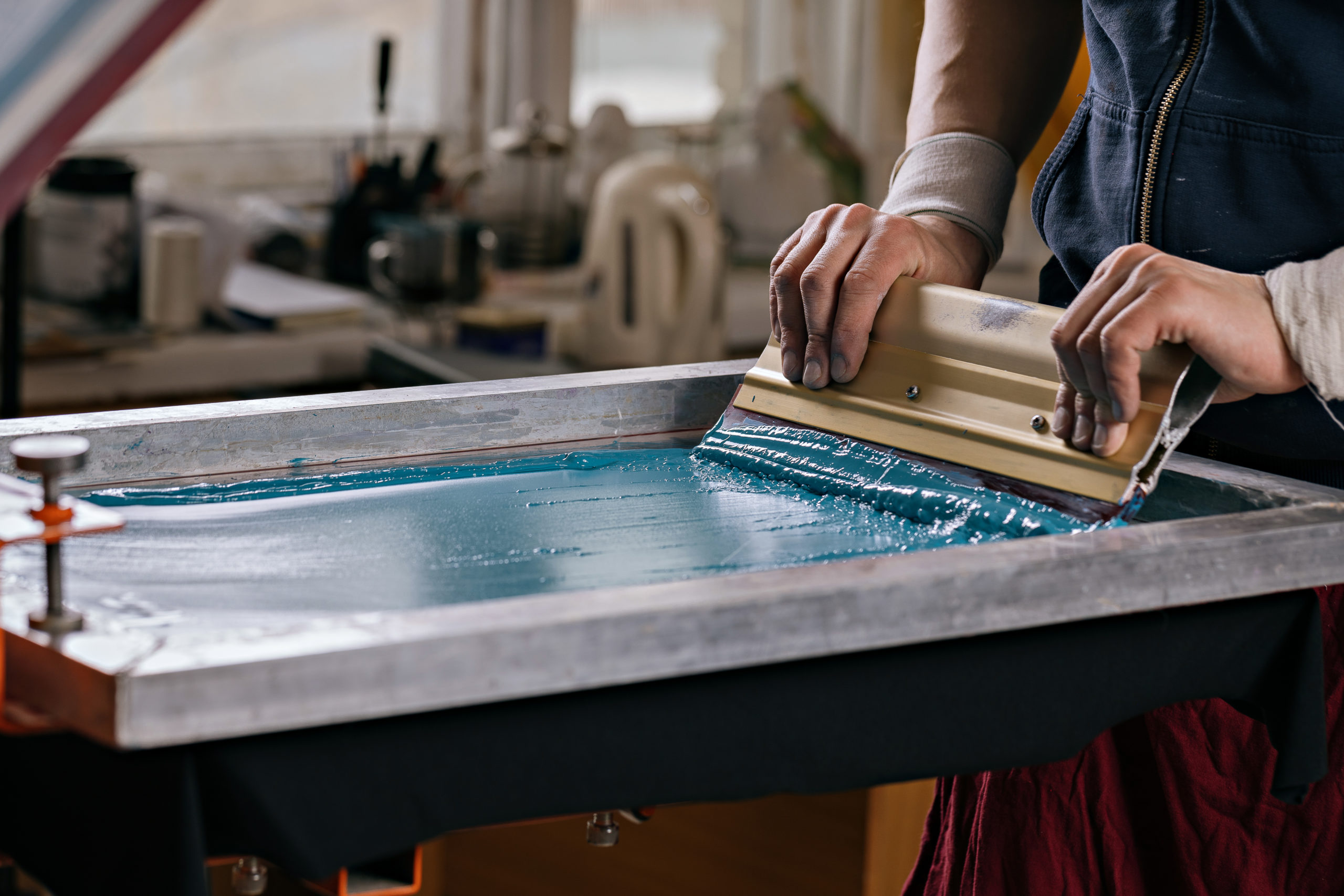 selective focus photo of male hands with squeegee. serigraphy pr